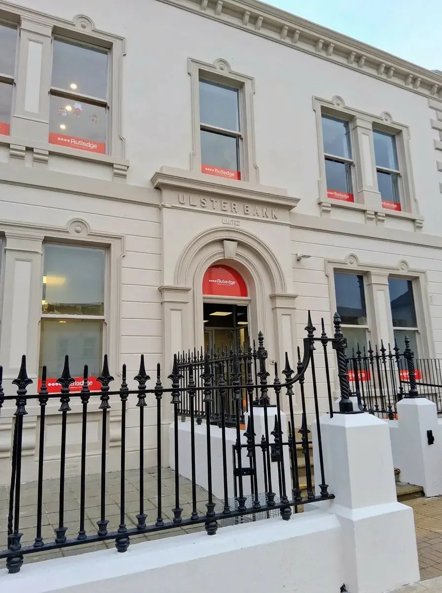 Rutledge Recruitment & Training Antrim branch in the restored Ulster Bank building, cream stone façade with black wrought-iron railings.