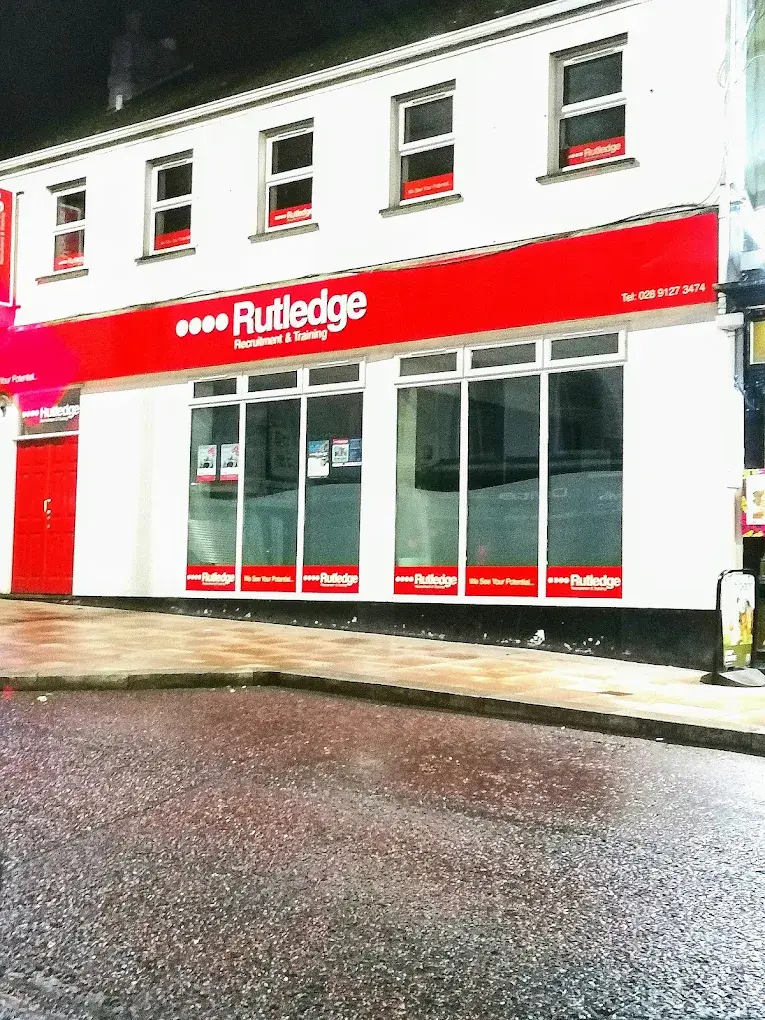 Rutledge Recruitment & Training Bangor branch, white two-storey building with a bold red Rutledge shopfront and red corner entrance door.